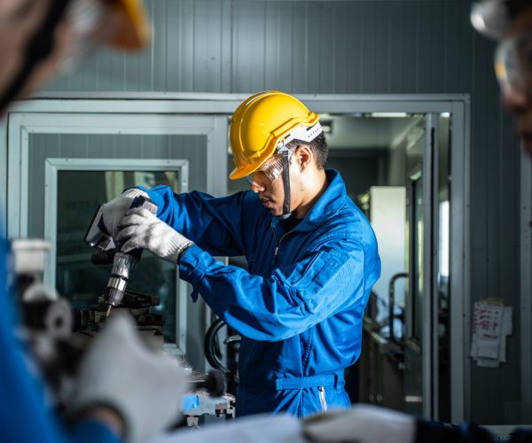 asian-mechanical-workers-working-on-milling-machin-2023-11-27-05-12-41-utc