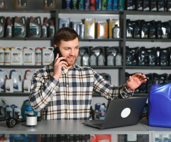 Auto parts store. The seller receives the product and evaluates the quality.